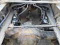 Close-up view of the undercarriage of a 2022 Freightliner Cascadia showing the drive axle and suspension components