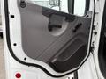 Door panel of a 2019 Freightliner M2 featuring a textured gray surface with a door handle and a control knob