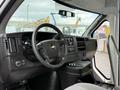 Interior view of a 2013 Chevrolet Express showcasing the steering wheel dashboard and control panel