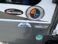 A 2013 Outdoor Wind River RV featuring a climate-designed logo for four seasons and various stickers including Mountain Extreme thermal windows
