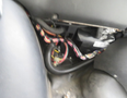 A 2020 Chevrolet Express with exposed wiring and components visible in the foreground