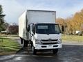 A white 2018 Hino 195 box truck with a flat front and large cargo area is parked on a road