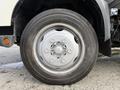 Close-up of a silver wheel and tire from a 2014 Hino 195 with visible tread and a five-bolt pattern on the rim
