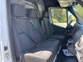 Interior of a 2019 Mercedes-Benz Sprinter showing front seats with seatbelts and a dashboard visible