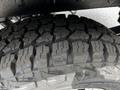 Close-up of a rugged tire with deep treads designed for enhanced traction and off-road performance on a 2022 Ford Transit