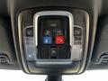The overhead console of a 2022 RAM 3500 featuring various buttons for assist services trunk release and lighting controls