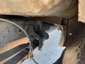 A close-up view of the underside of a 2016 Ford F-250 SD showing the frame and suspension components with visible rust and wear