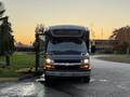 A 2019 Chevrolet Express van is parked with its doors open showing a spacious interior and a front view featuring headlights and a Chevrolet emblem