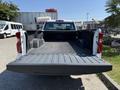 A 2021 Chevrolet Silverado 1500 with an open truck bed showcasing a lined cargo area and sturdy tailgate