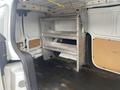 A 2017 Ford Transit Connect with shelving units installed in the rear cargo area