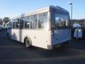 A white 2016 Chevrolet Express bus with large windows and a rear view design