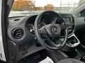 Interior of a 2019 Mercedes-Benz Metris featuring a black steering wheel with controls a dashboard with gauges and a central display screen