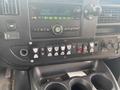 Interior dashboard of a 2016 Chevrolet Express with radio controls and various buttons for vehicle functions