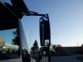 A 2014 International Durastar truck with a prominently displayed side mirror showing a reflection of the truck's cabin