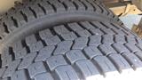 Close-up of a tire tread on a 2006 Ford Econoline showing clear, deep grooves designed for traction and stability