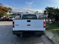 A white 2008 Ford F-150 XL viewed from the rear showcasing its tailgate and rear bumper