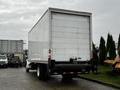 A 2018 Freightliner M2 106 delivery truck with a white cargo box and rear lights visible