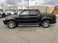 A black 2004 Ford Explorer Sport Trac with a four-door cab and a short truck bed on the back