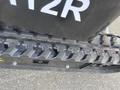 Close-up of the tracks on a 2024 AGT Mini Excavator showing the tread pattern and undercarriage details