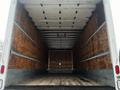 Interior view of a 2020 Hino 338 truck showing a spacious empty cargo storage area with wooden paneling and a flat wooden floor