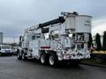 A 2011 Western Star Trucks 4900 equipped with a large bucket lift and storage compartments on the side