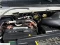 Close-up of the engine compartment of a 2010 Ford Econoline highlighting the battery hoses and various engine components