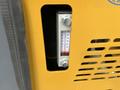 Close-up of a temperature gauge on a yellow AGT Industrial H13R mini excavator showing a reading between 100 and 220 degrees