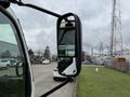 A side mirror of a 2014 Hino 195 truck reflecting a view of surroundings