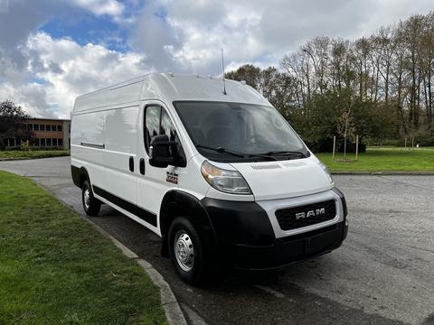 2016 RAM Promaster van with a white exterior and black front grille parked on a street