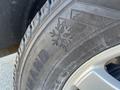Close-up of a tire from a 2013 Ford Expedition showing tread pattern with a snowflake symbol indicating winter capability