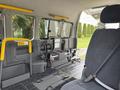 Interior of a 2009 Toyota Hiace showing a wheelchair ramp and a single driver's seat with fabric upholstery