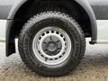 A close-up of a tire and wheel of a 2017 Mercedes-Benz Sprinter featuring a Goodyear Wrangler tire mounted on a silver rim