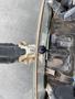 A close-up of the control levers and dashboard of a 2012 John Deere 310SJ backhoe loader with various switches and indicators visible