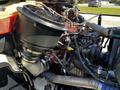 A close-up view of the engine compartment of a 2012 Freightliner M2 112 showing various engine components including air intake and hoses