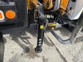 A hydraulic cylinder attached to the chassis of a 2011 International 4300 truck with warning labels and controls visible