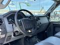 Interior view of a 2012 Ford F-450 Super Duty with a black steering wheel dashboard controls and textured surfaces