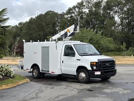 2017 Ford Econoline van with a raised ladder and utility body designed for service work