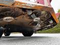 Underside view of a 2012 Toro Groundsmaster mower highlighting rusty blades and components