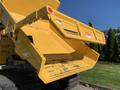 A yellow TerraMac RT7R dump box with an open flap showing a slightly worn surface designed for transporting materials