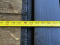 A yellow measuring tape laid across a wooden surface showing measurements from 188 to 198