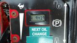 A digital hour meter displaying 943.9 hours on a 2014 Ferris Mower ISX 800 with a green label indicating the next oil change