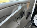 The interior door handle and controls of a 2017 Chevrolet Express with a grey finish and textured surface