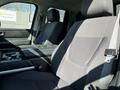 The interior of a 2023 Toyota Tundra featuring a spacious front seat with gray fabric upholstery and a center console
