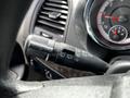 A close-up of the turn signal and windshield wiper control lever inside a 2011 Dodge Grand Caravan