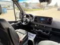 Interior view of a 2019 Mercedes-Benz Sprinter featuring a steering wheel and dashboard with a digital display and controls for audio and climate settings