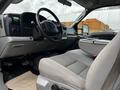Interior of a 2007 Ford F-550 featuring a gray bench seat and dashboard with various controls and a steering wheel