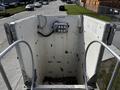 Aerial view of a bucket lift with a control panel mounted inside, designed for elevating personnel or equipment, showing faded surfaces and some wear marks
