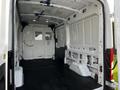 Interior view of a 2020 Ford Transit cargo van showing an empty space with rubber flooring and solid walls without furnishings or equipment