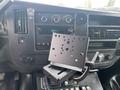 The interior dashboard of a 2014 Chevrolet Express with a mounted device holder and car radio showing the time 1241