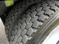 Close-up of the tread on a tire of a 2006 Freightliner M2 112 showing deep grooves and a rugged texture